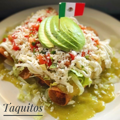 taquitos with cheese, avocados, and little mexican flag sticking out on top