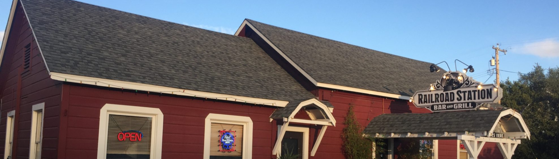 railroad station bar and grill exterior. barn red with white trim.