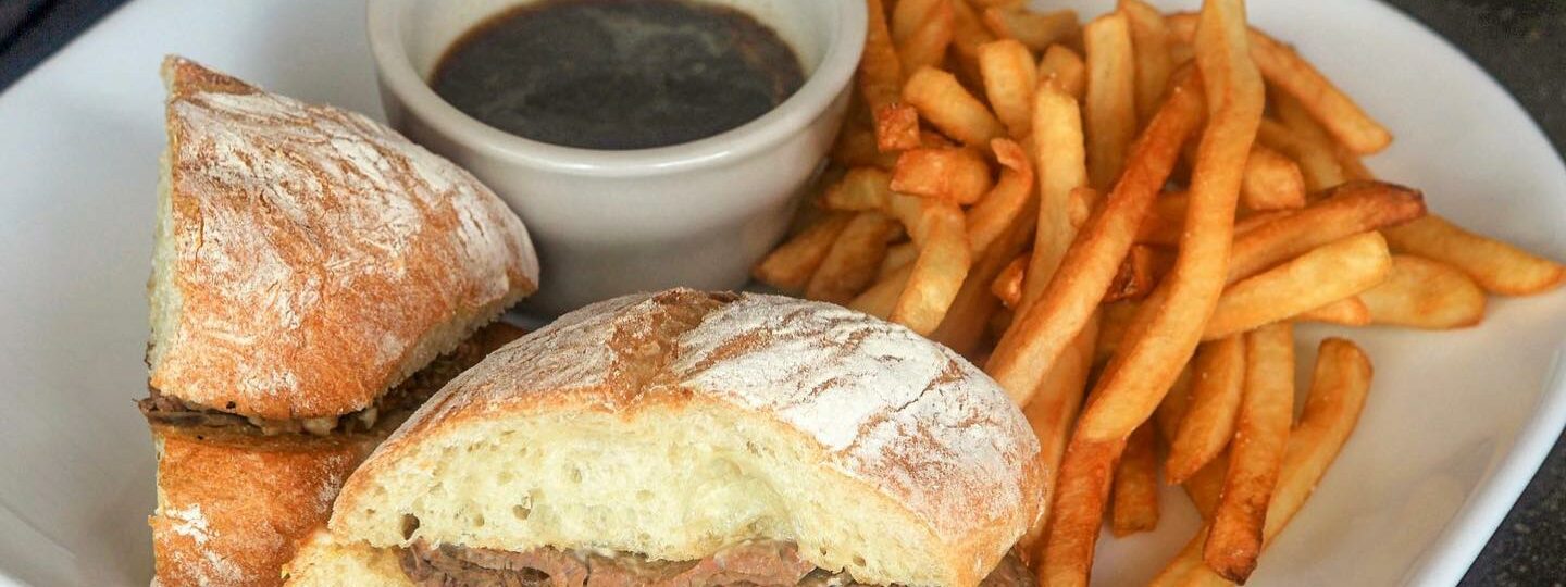 Ricardo's bar and Grill prime rib roast beef sandwich and French dip with fries.