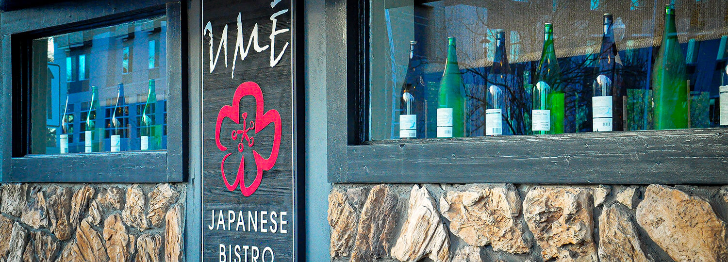 Ume Bistro Japanese Bistro. Stone exterior with sake bottle in the windows.
